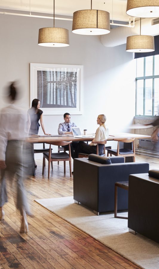 Business people at work in a busy luxury office space